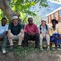 John, Paul, Henry, Susi and Consalva sitting beside the school building.
